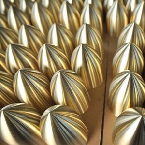 The image shows precision-manufactured copper spun components with polished surface finish, demonstrating high repeatability and surface consistency in batch production.